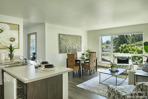 A modern kitchen with a dining table and chairs.