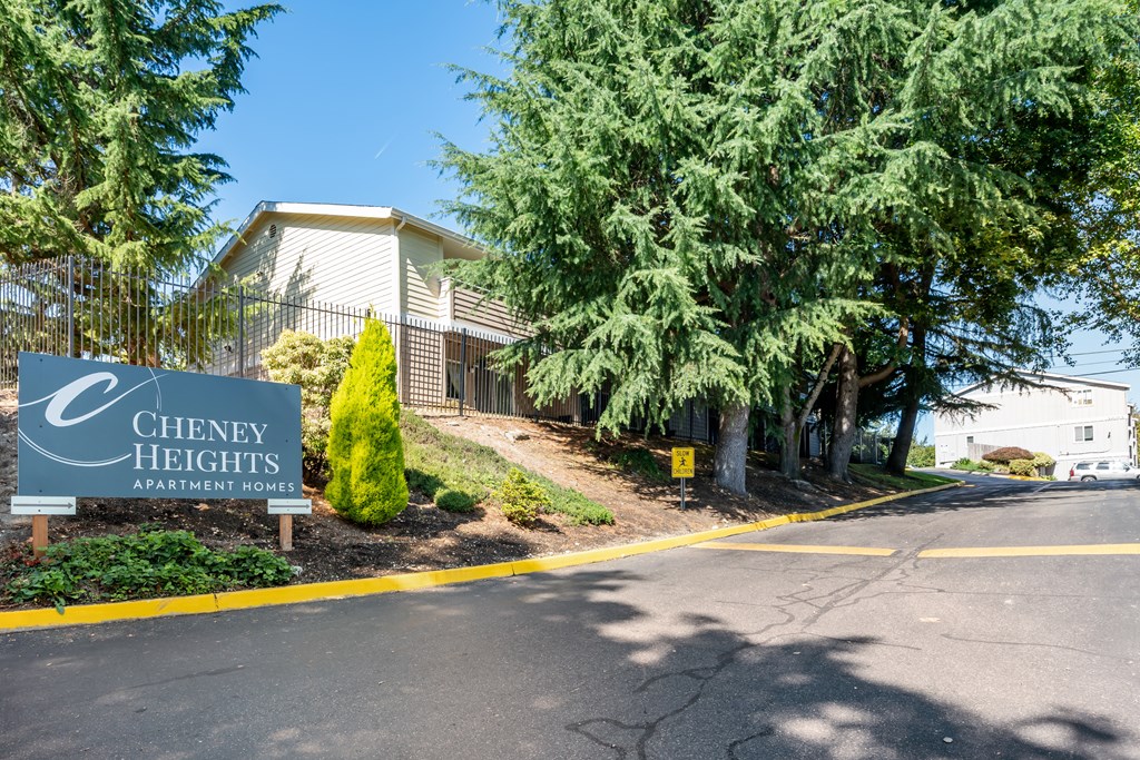 A sign for Cheney Heights Apartment Homes is in front of a building.