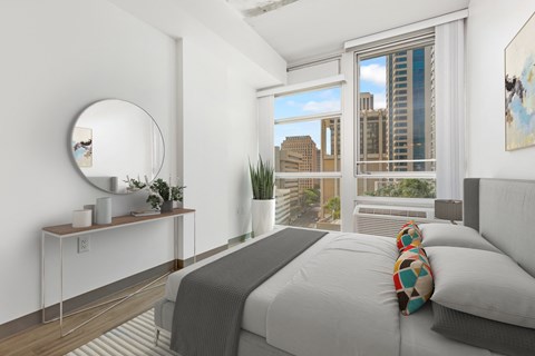a bedroom with a bed and a city view