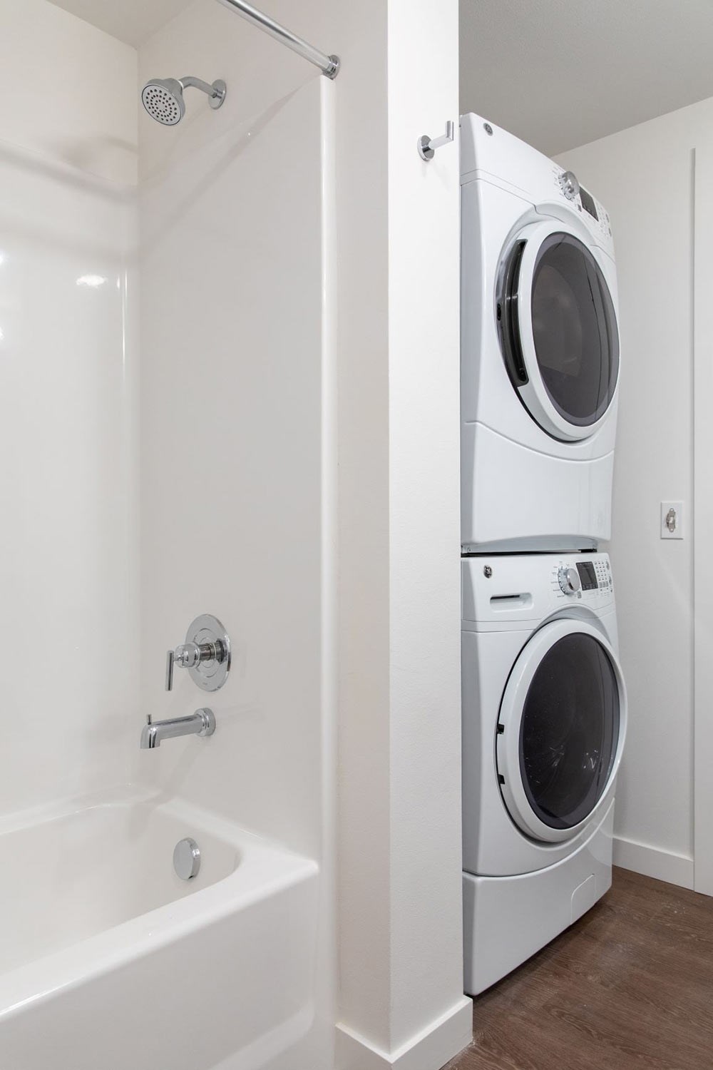 a washer and dryer in a bathroom next to a tub