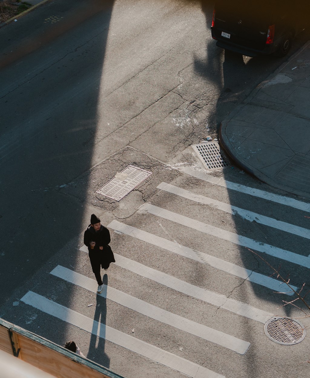 a man crossing the street on a cross walk