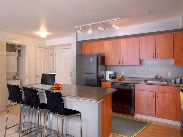 a kitchen with an island with a laptop computer on it