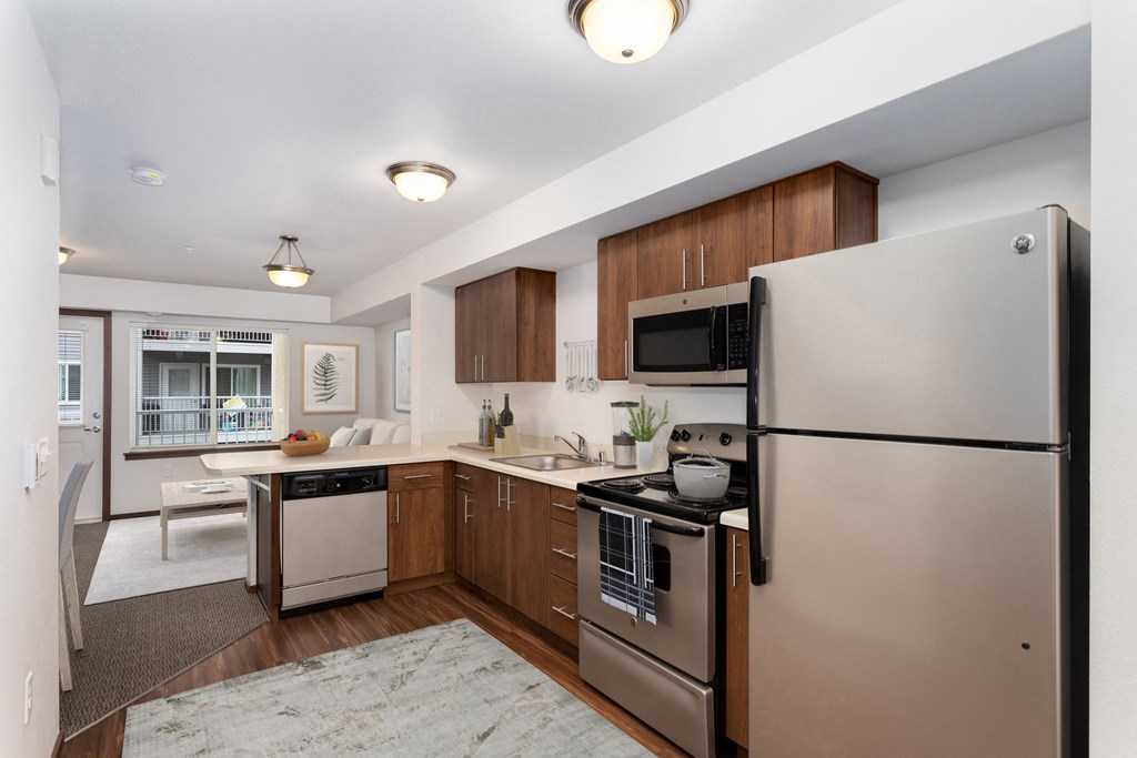 a kitchen with stainless steel appliances and wooden cabinets
