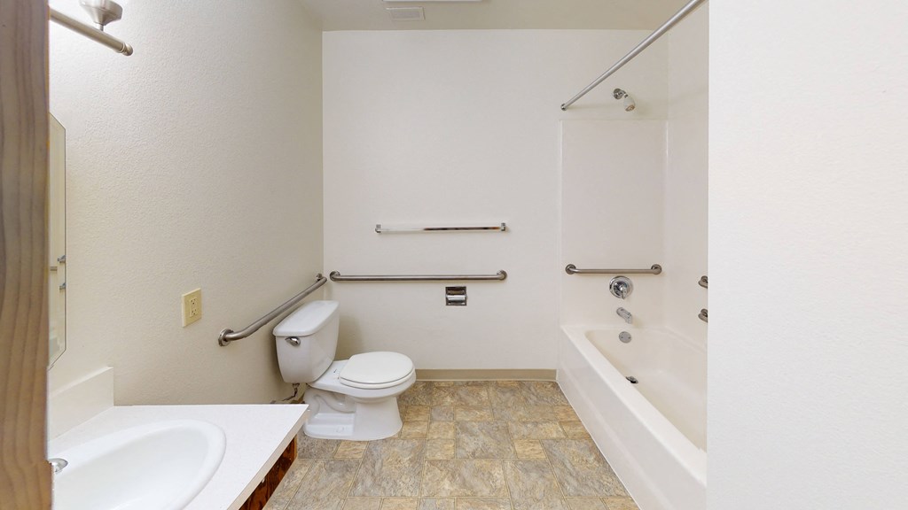 a bathroom with a toilet and a tub and a sink