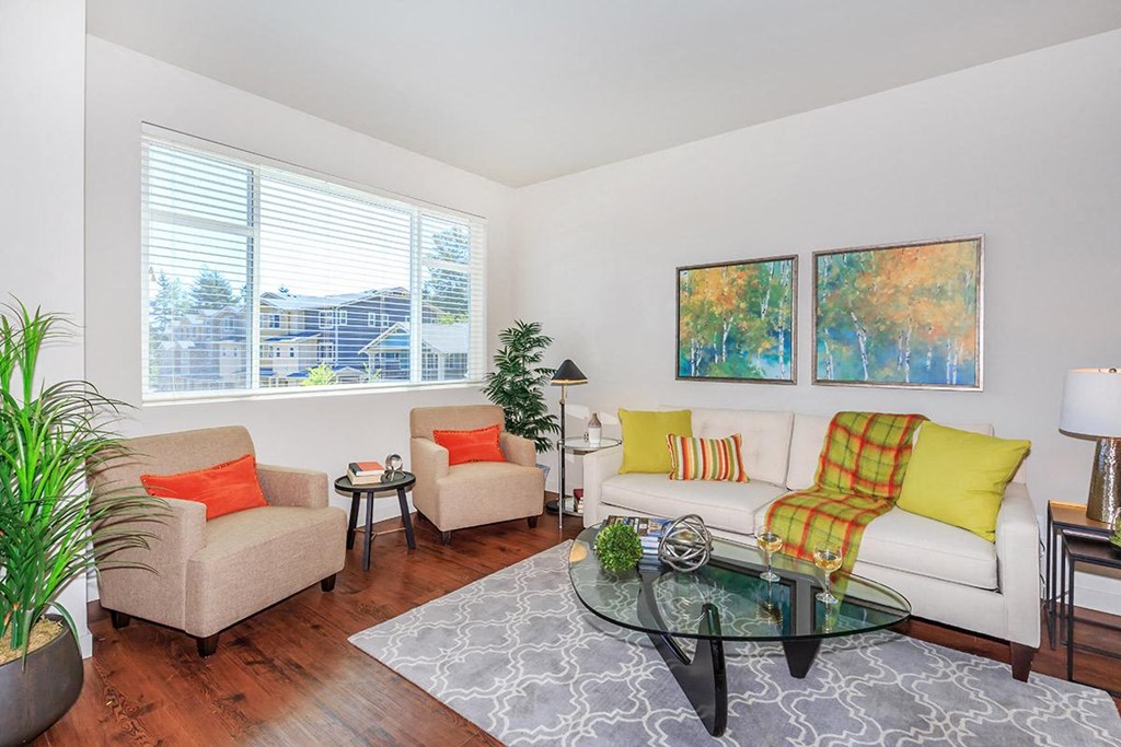 a living room with two couches and a glass coffee table