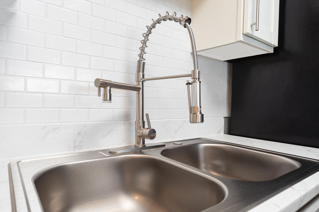 a close up of a kitchen sink with a faucet