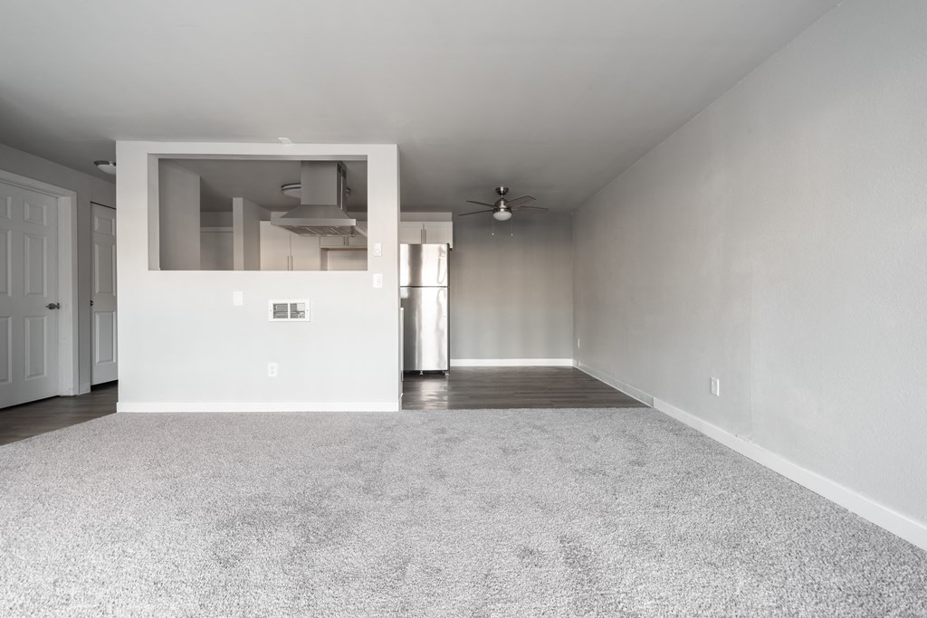 an empty living room with white walls and a white carpet