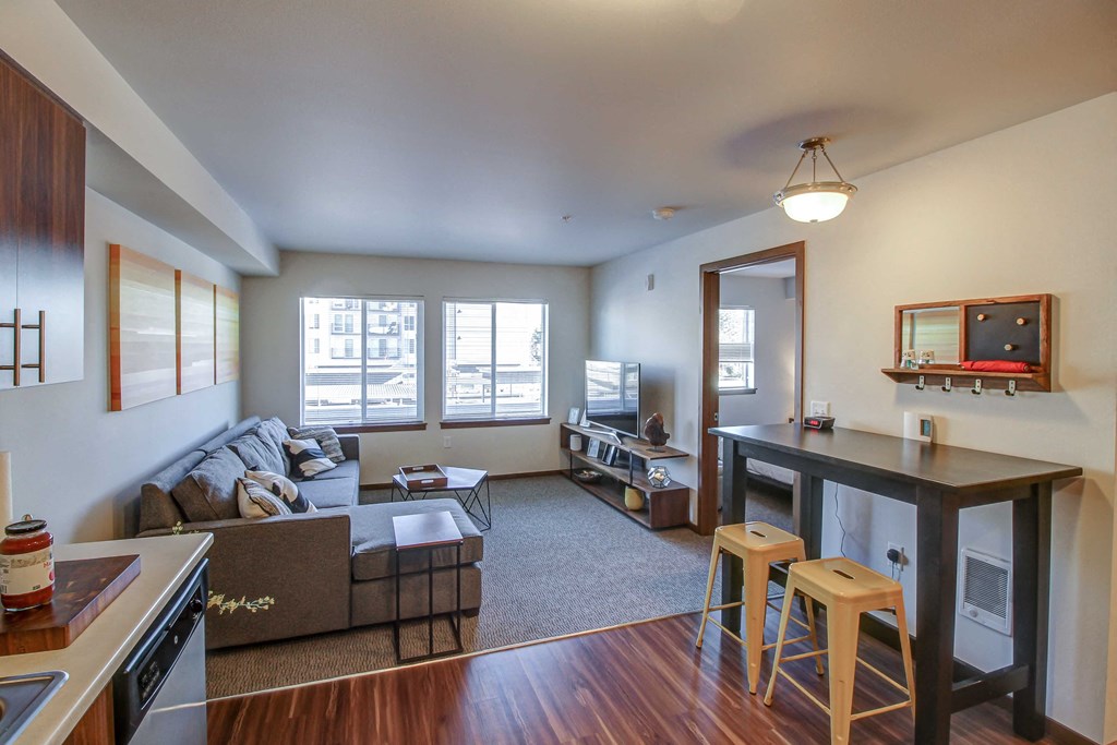 a living room with a couch and a bar and a kitchen