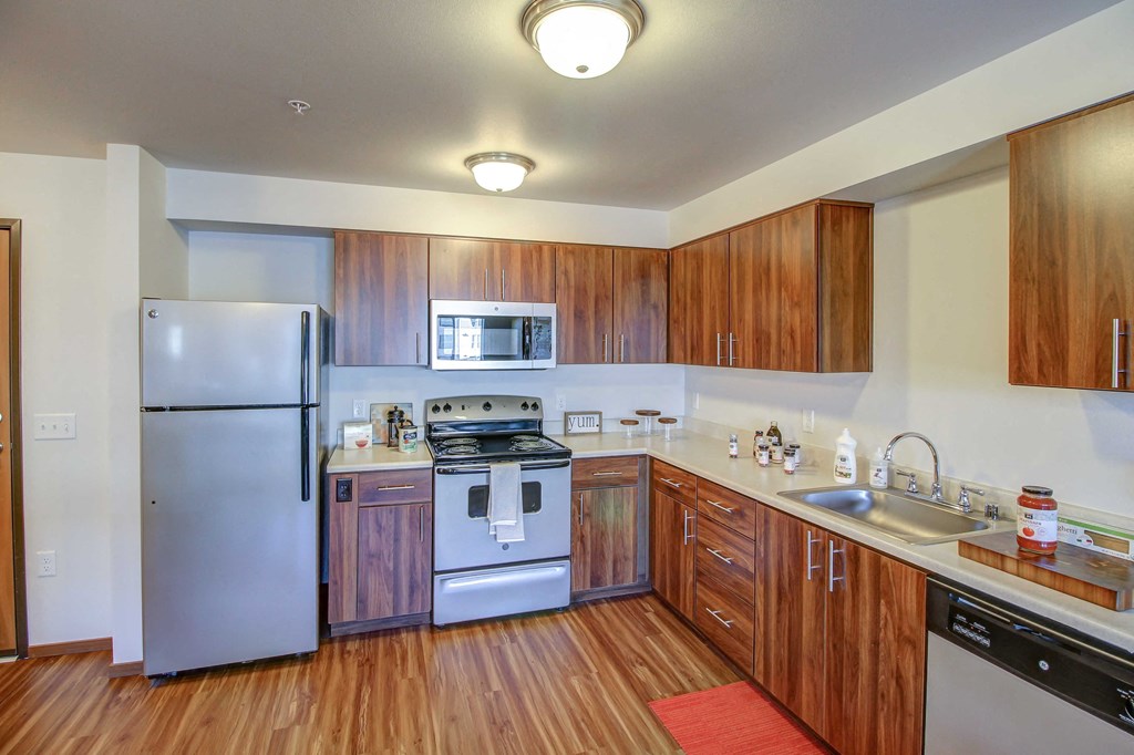 a kitchen with stainless steel appliances and wooden cabinets