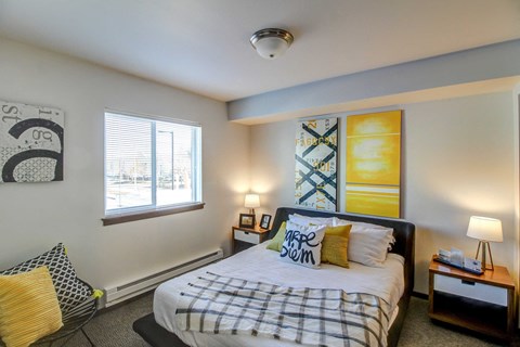 a bedroom with a bed and a window