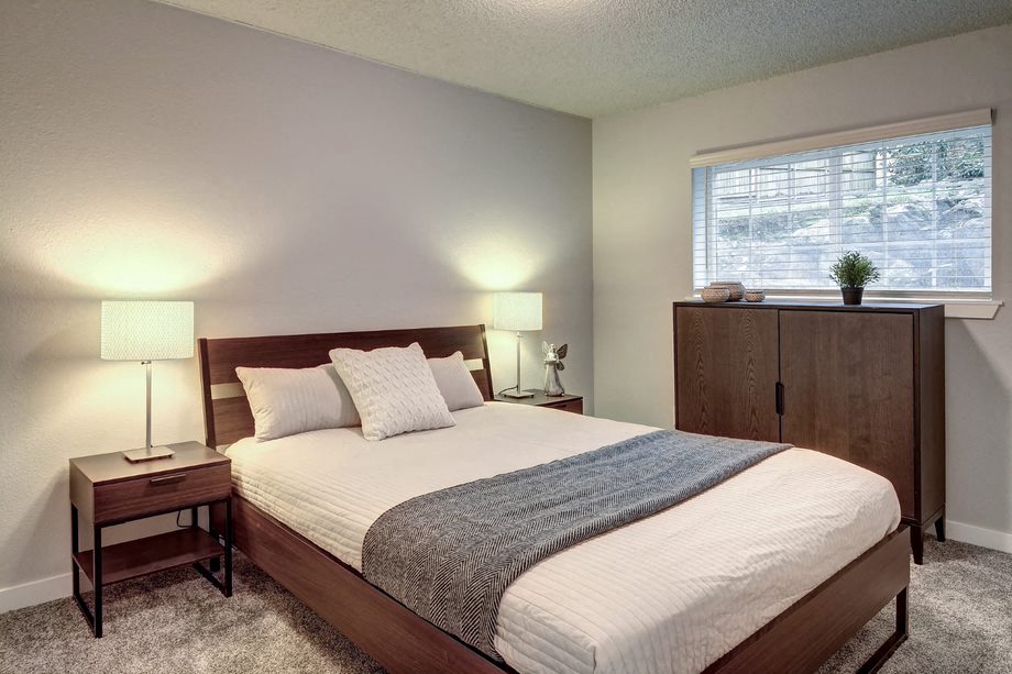 a bedroom with a bed and a window