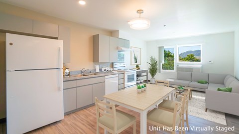 A modern kitchen with a dining table and chairs.