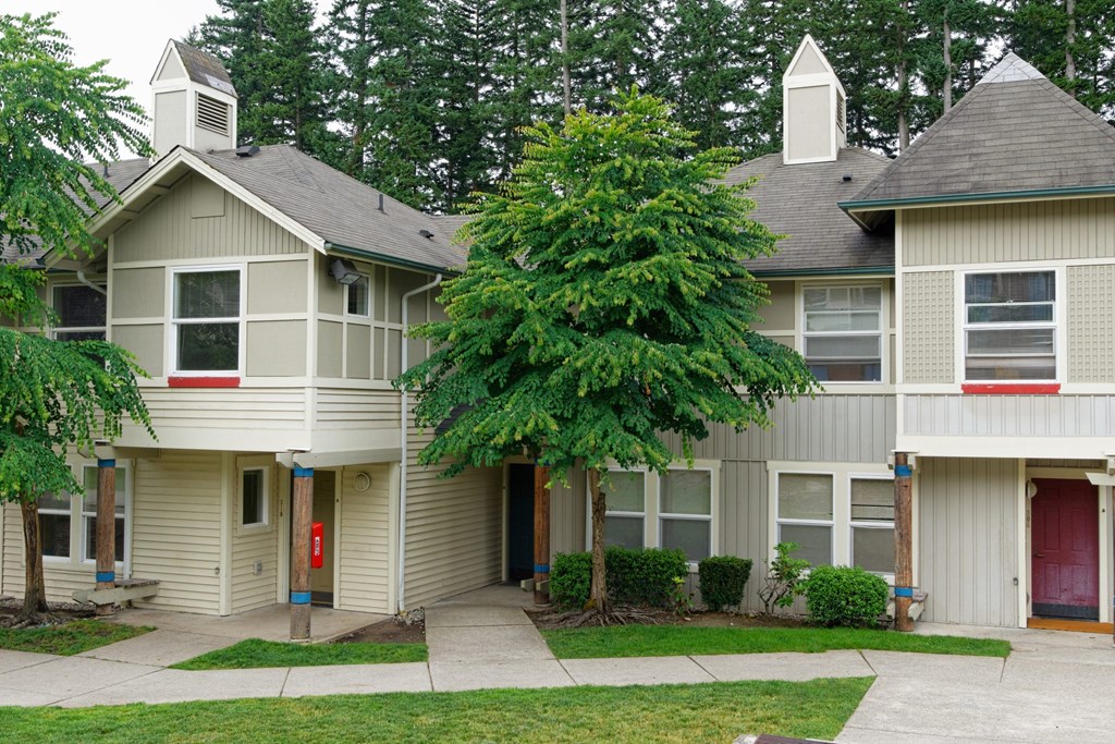 A tree in front of a house.