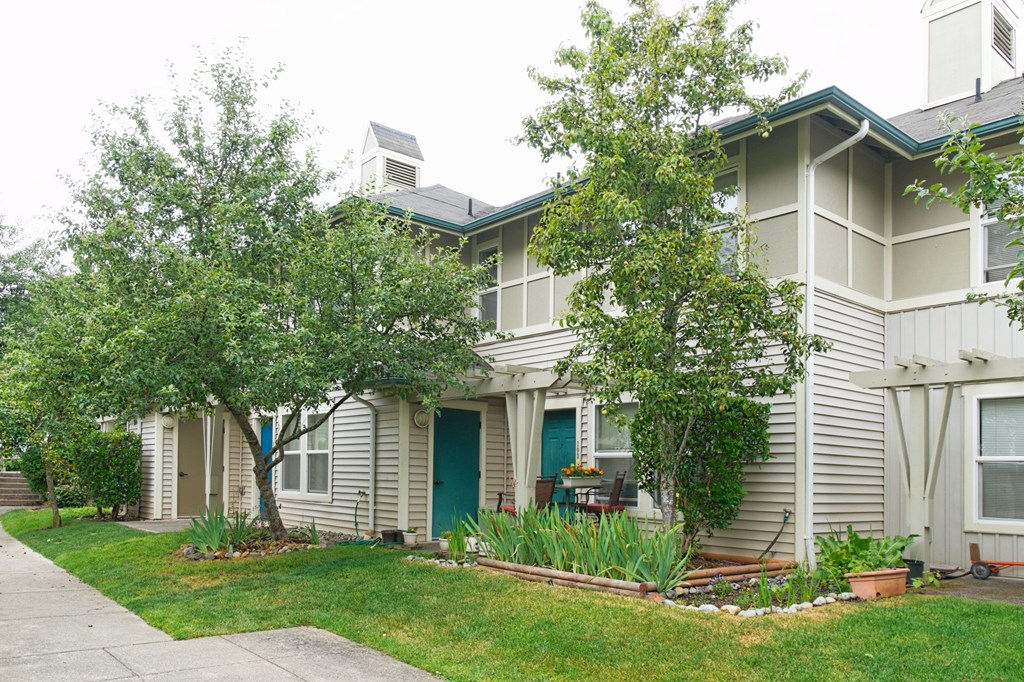 A house with a blue door and a green lawn.