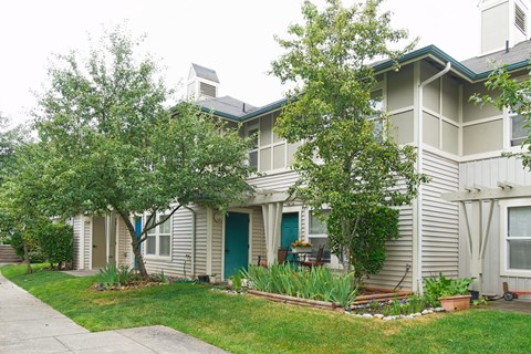 A house with a blue door and a green lawn.