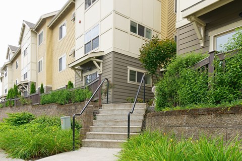 A staircase with a railing leads up to a building.