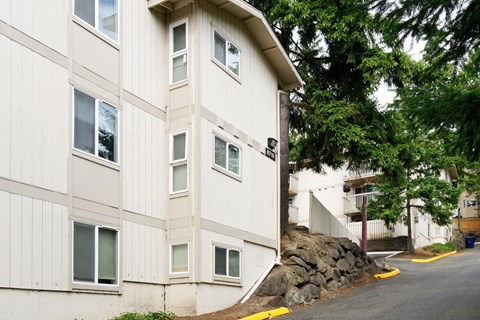 A white building with a yellow curb in front of it.