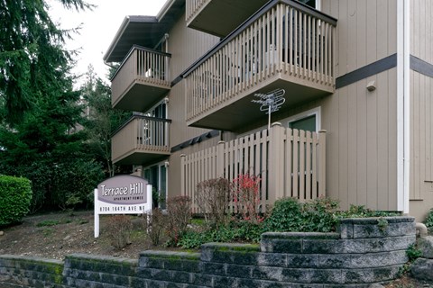 A sign in front of a building that says Terrace Hill.