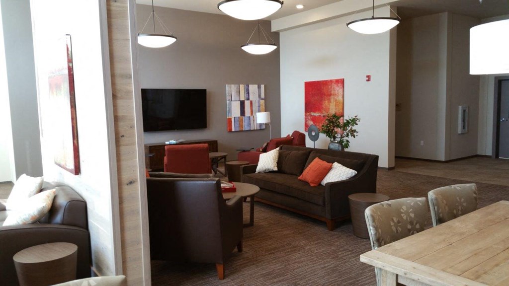 a living room with couches and chairs and a table