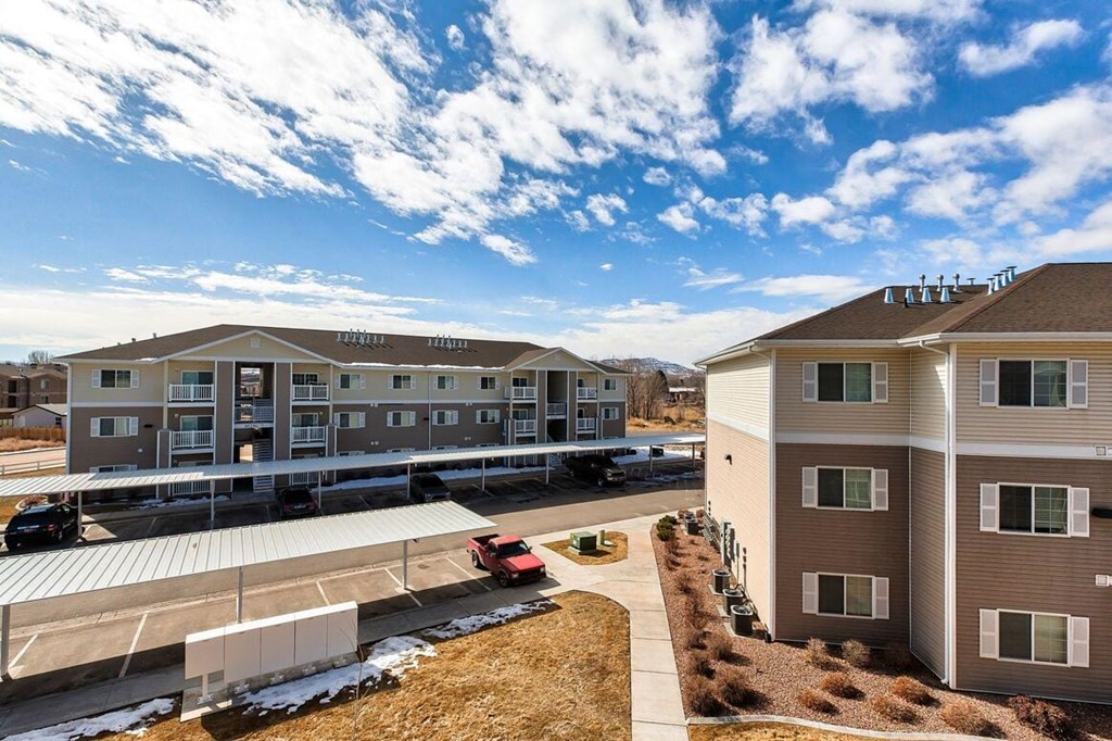 an aerial view of a building with a red truck parked in front of it