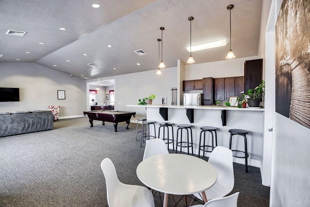 a game room with a pool table and a bar
