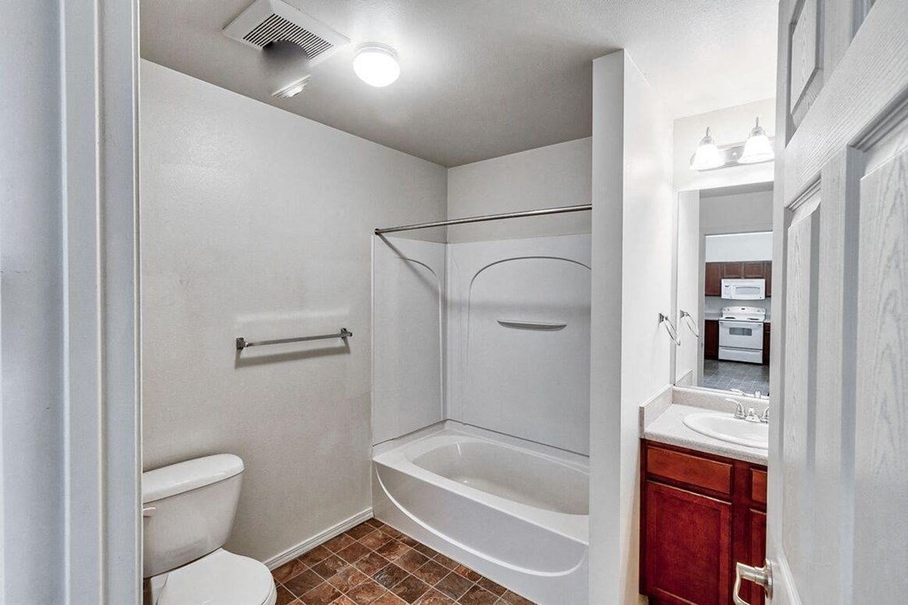 a bathroom with a shower and a toilet and a sink
