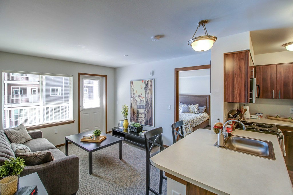 a kitchen and living room with a couch and a table