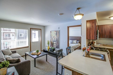 a kitchen and living room with a couch and a table