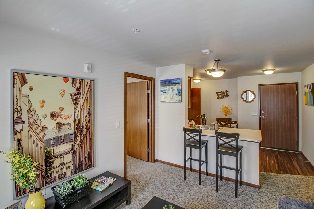 a living room with a bar and a dining room