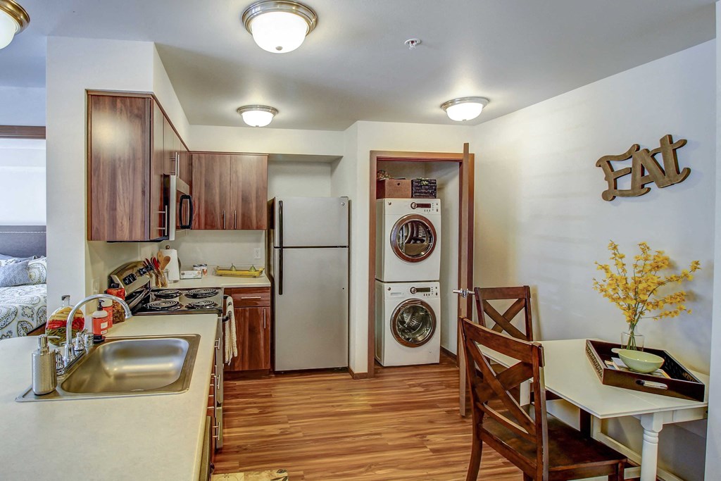 a kitchen and dining room with a washer and dryer and a laundry room