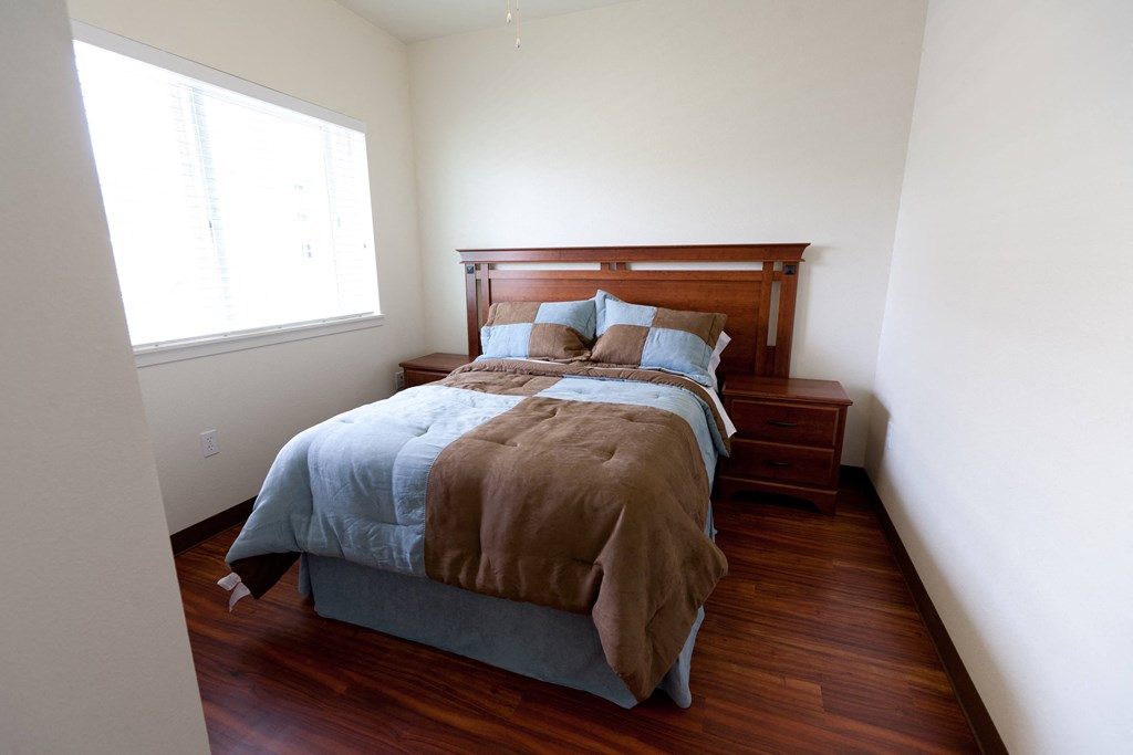 a bedroom with a bed and a window