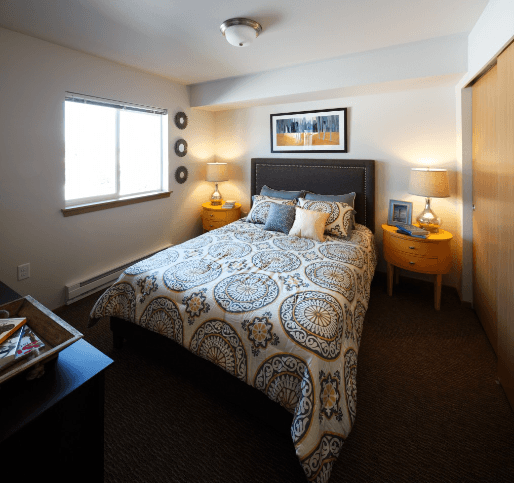 a bedroom with a bed and two night stands