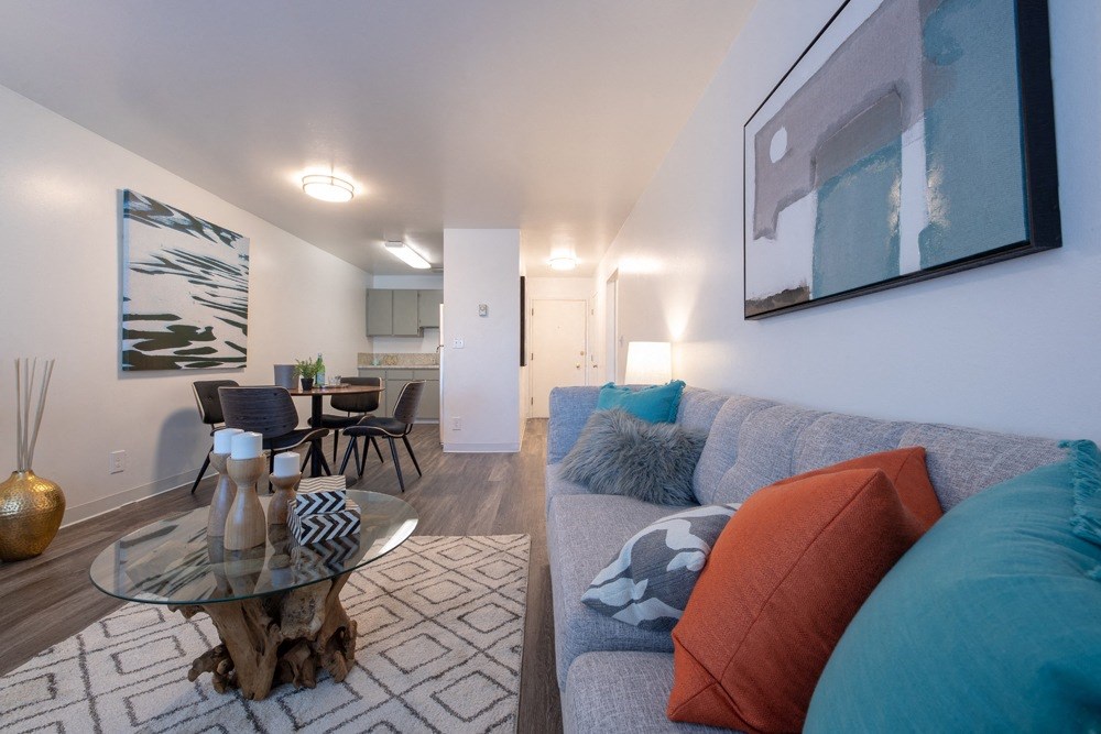 a living room and dining room with a couch and a table