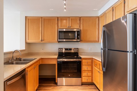 A kitchen with wooden cabinets and stainless steel appliances.