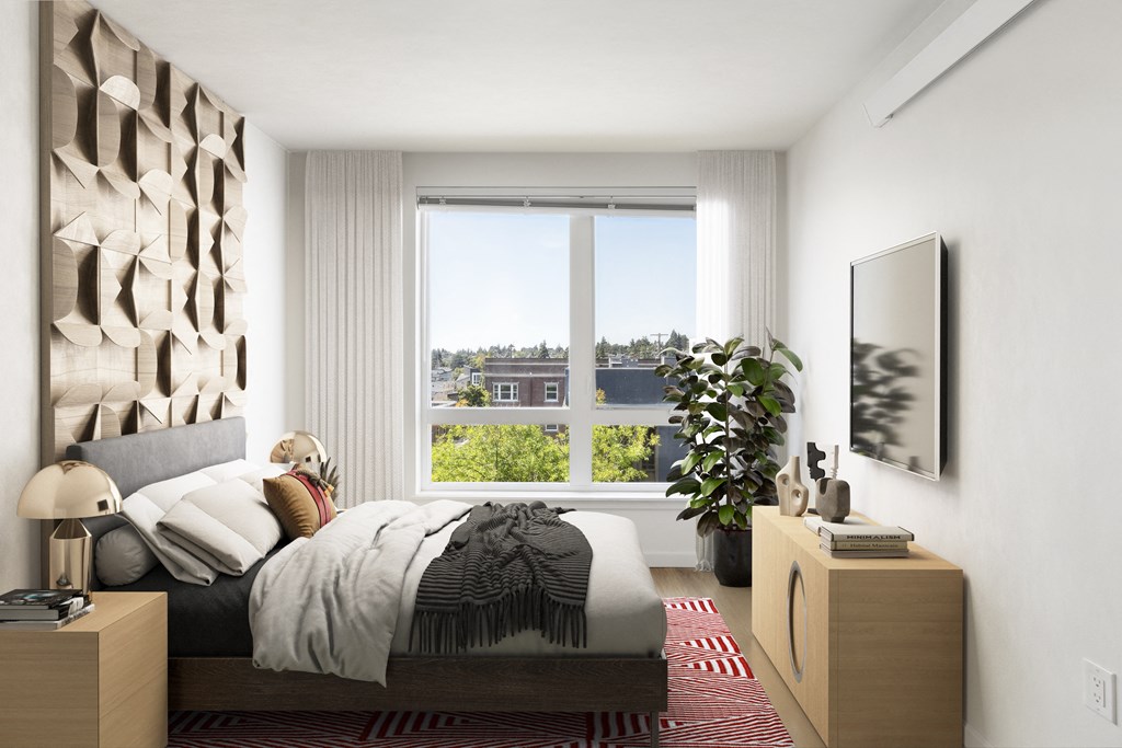 a bedroom with a bed and a large window