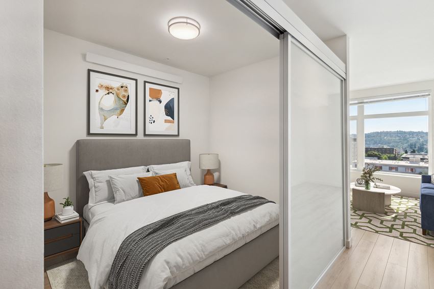 a bedroom with a large bed and a sliding glass door to a balcony - Photo Gallery