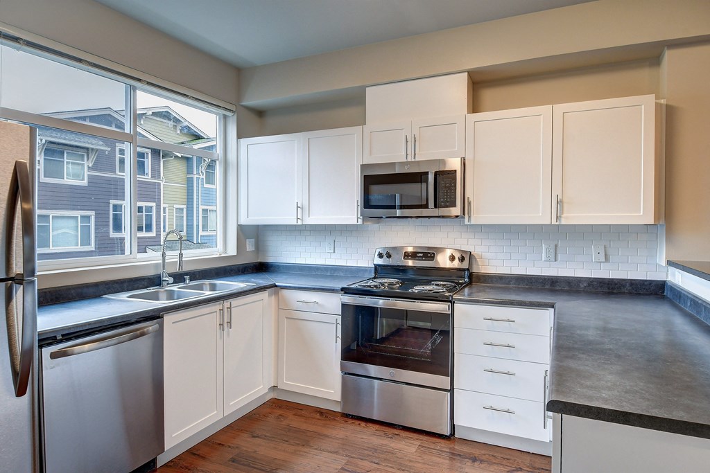 a kitchen with stainless steel appliances and a window