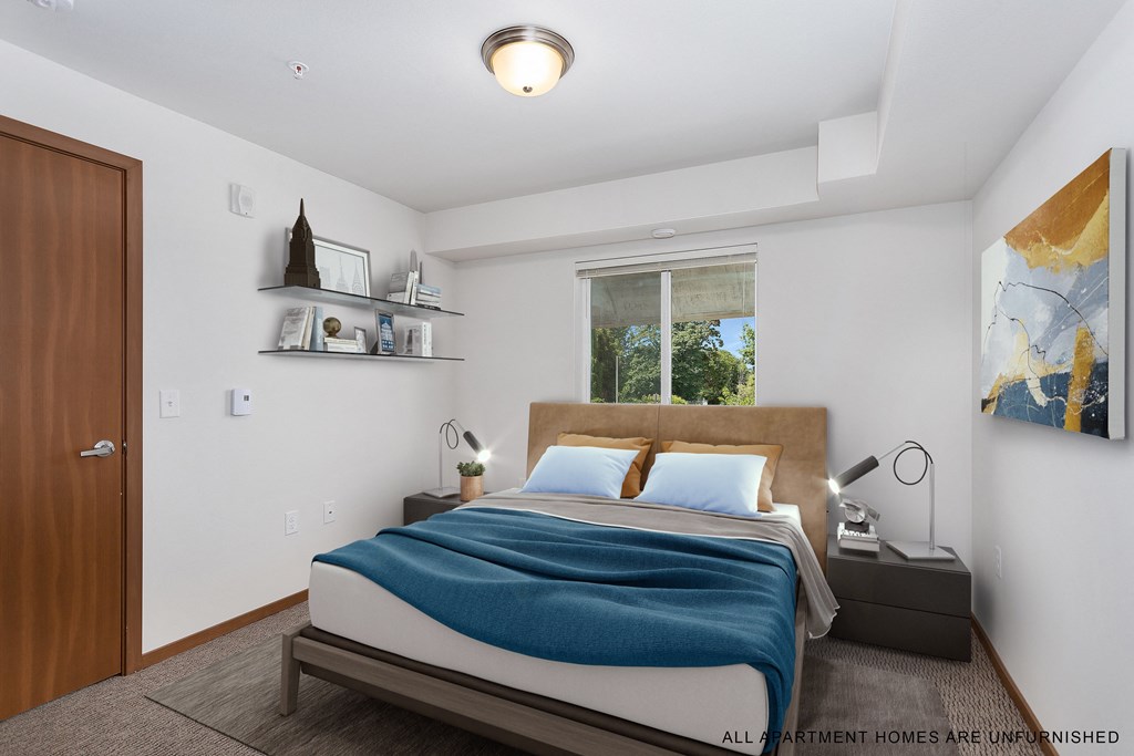 a bedroom with a bed and a large window