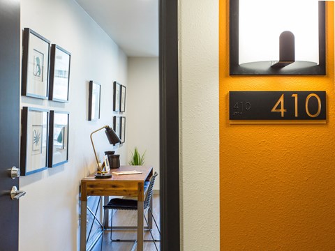 a home office with a desk and a clock on the wall