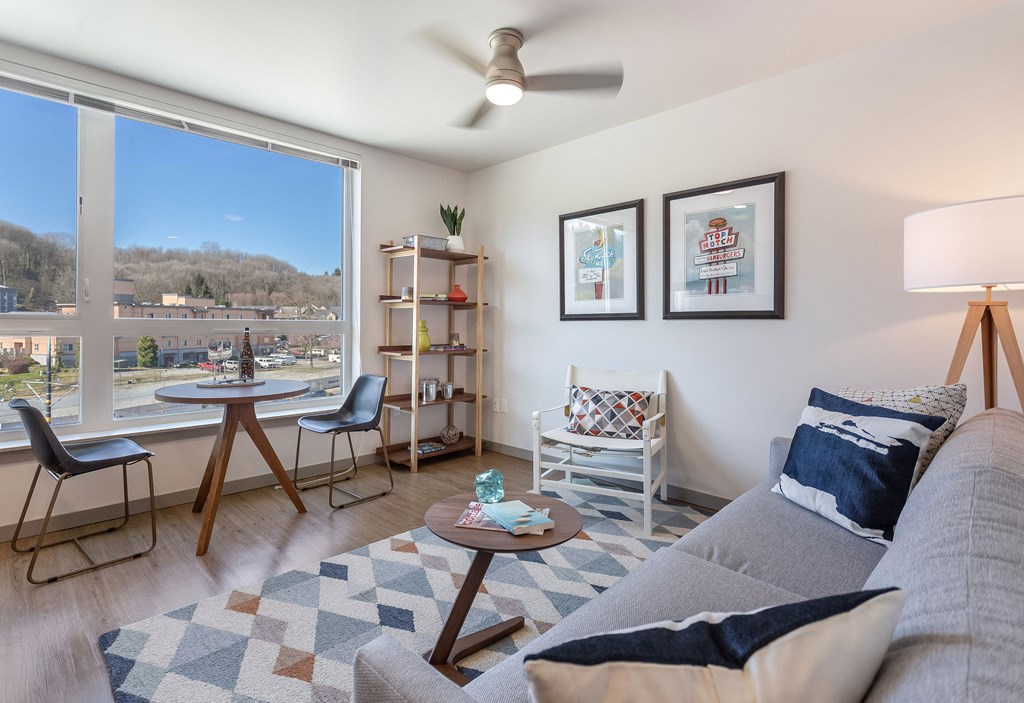a living room with a couch and a table and a large window