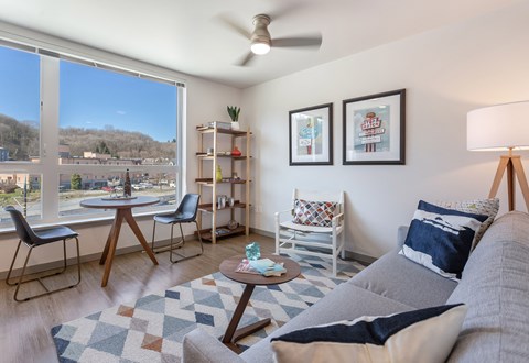 a living room with a couch and a table and a large window