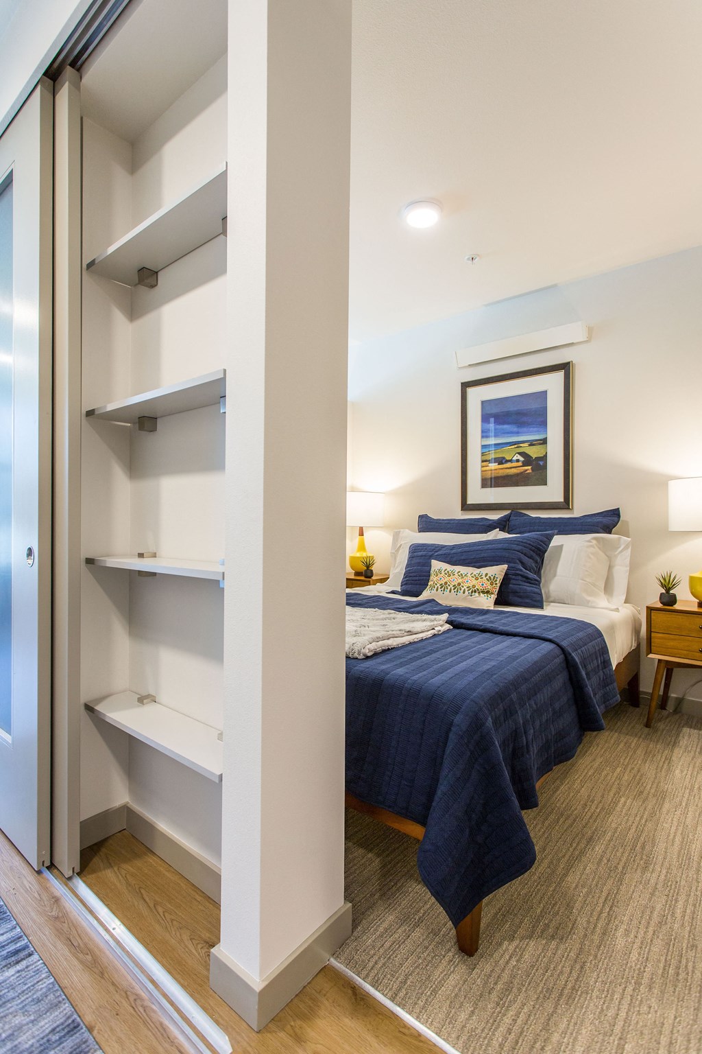 two beds in a room next to a closet