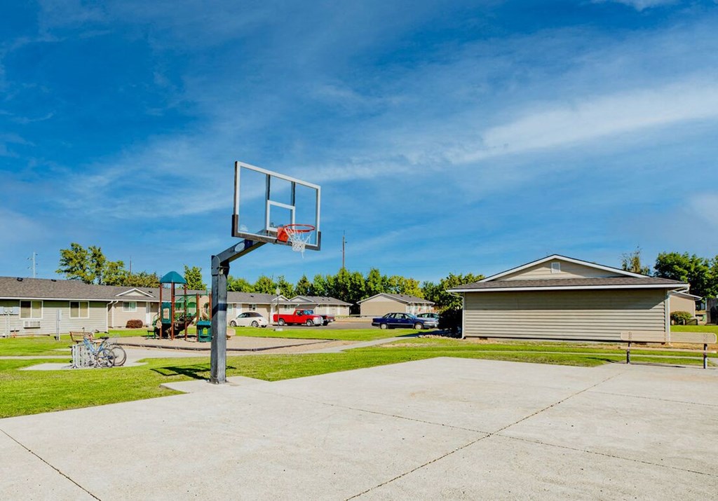 the basketball hoop is in the driveway of a house