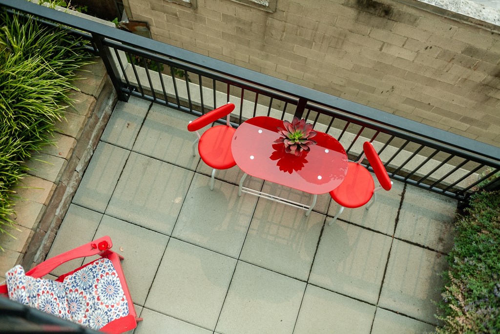 a red table and chairs on a patio
