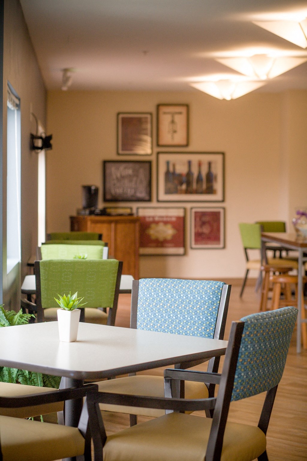 a dining room with tables and chairs and pictures on the wall