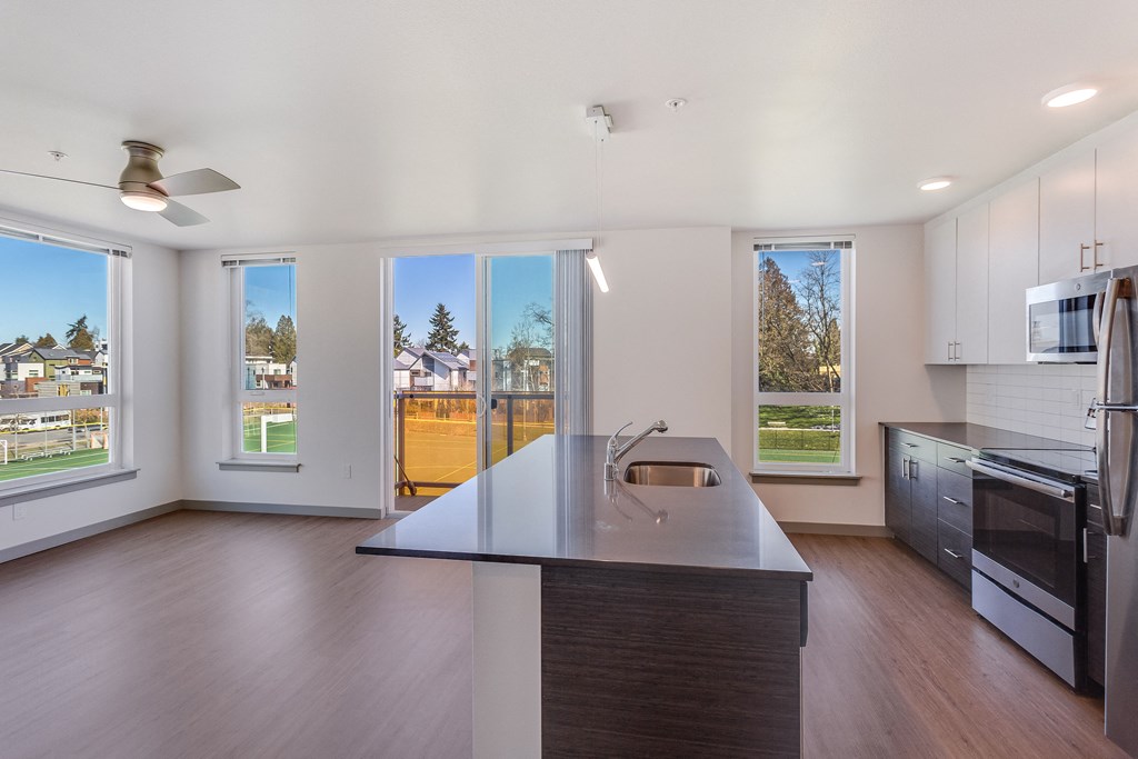 an empty kitchen with a large island in the middle