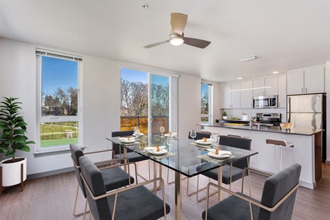 a dining room with a glass table and chairs