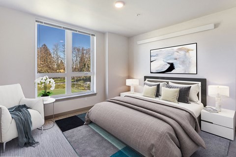 a bedroom with a bed and a large window