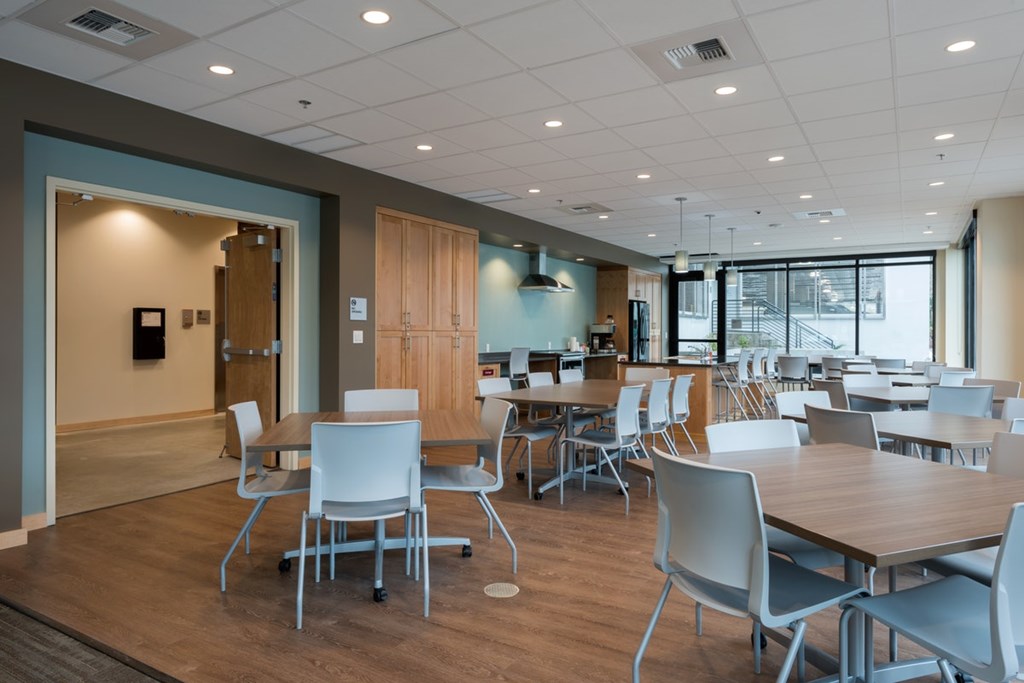 A conference room with a long table and chairs.