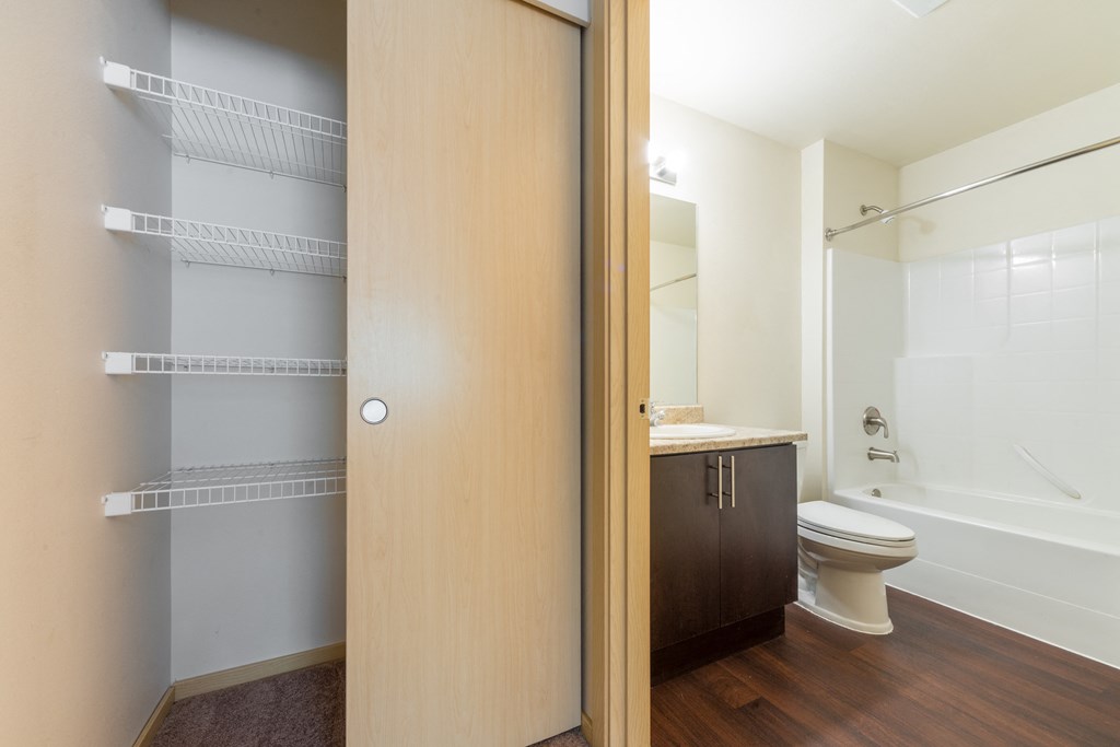 a bathroom with a toilet sink and bathtub in a 555 waverly unit
